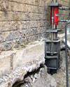 A completed installation of foundation push piers lifting a foundation in Westport