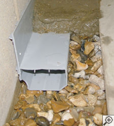A no-clog basement french drain system installed in Greenwich