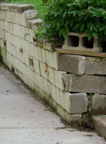 collapsing retaining wall with severe damage in Watertown