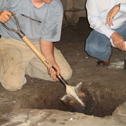 Digging a hole for the engineered fill used in a crawl space support system installation in Poughkeepsie