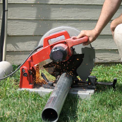 Cutting the support beam for a crawl space jack post outside a Trumbull home.