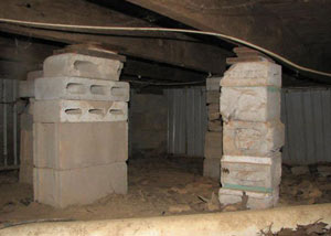 crawl space repairs done with concrete cinder blocks and wood shims in a Danbury home