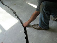 a severely damaged cracked concrete slab floor in Meriden