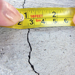 A crack in a poured concrete wall that's showing a normal crack during curing in Westport