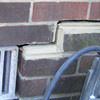 A closeup of a failed tuckpointing job where the brick cracked on a East Lyme home.