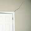 A long drywall crack beginning at the corner of a doorway in a Meriden home.