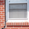 A gap in a window along the outer wall due to foundation settlement of a Simsbury home.