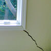 A long, diagonal crack that begins at a window corner of a Stratford home