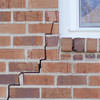 long jagged cracks starting at the corner of a window along a brick wall on a Danbury home