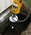 Installing a helical pier during a foundation repair in Greenwich