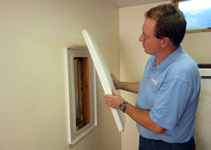 Foundation wall anchor covers installed in a finished basement with a repaired foundation wall in Avon.