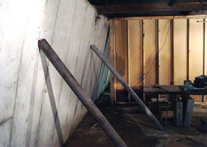 A severely tilting foundation wall propped up by steel beams in East Lyme.