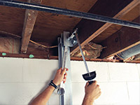 Straightening a foundation wall with the PowerBrace™ i-beam system in a Darien home.