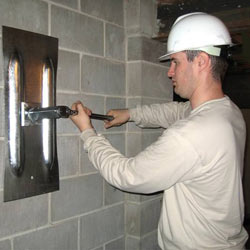 installing a wall anchor to repair an bowing foundation wall in Darien