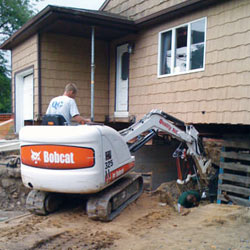 Excavating to expose the foundation walls and footings for a replacement job in New Canaan