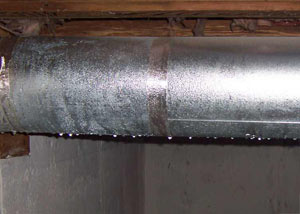 condensation collecting on an HVAC vent in a humid Glastonbury basement
