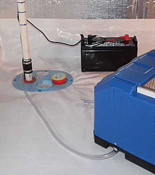 Closeup of a crawl space sump pump installed in Mystic