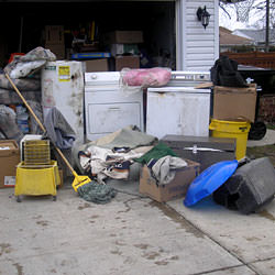 Soaked, wet personal items sitting in a driveway, including a washer and dryer in Poughkeepsie.