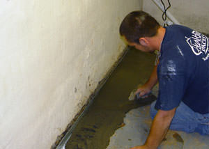 Restoring a concrete slab floor with fresh concrete after jackhammering it and installing a drain system in North Haven.