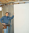 Installing wall panels on top of our basement wall insulation in Poughkeepsie